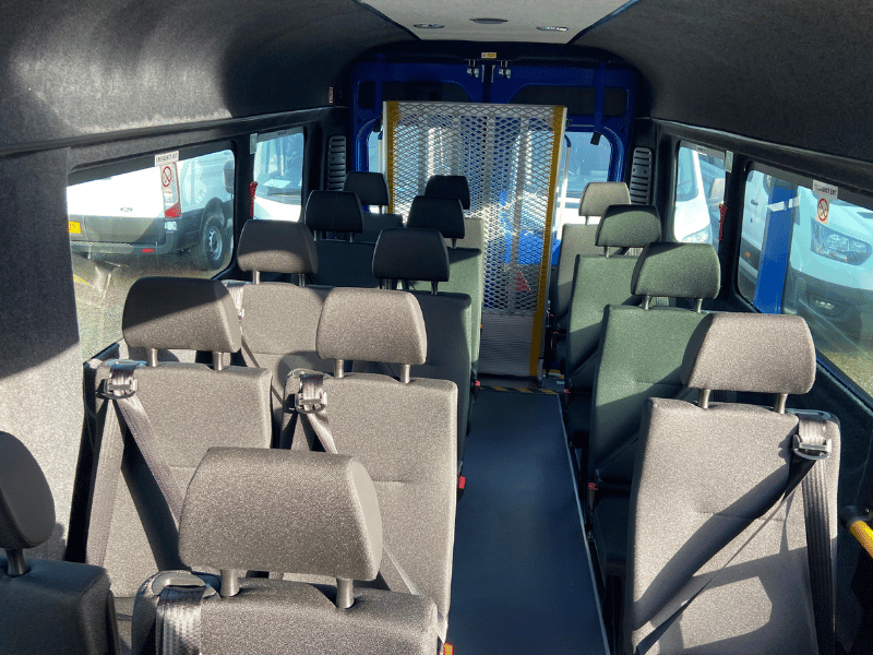 Interior of a CVM accessible minibus — grab rails, belts and wheelchair bay