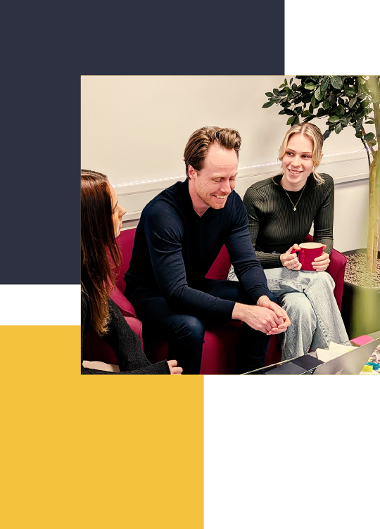 two women and a man sitting talking