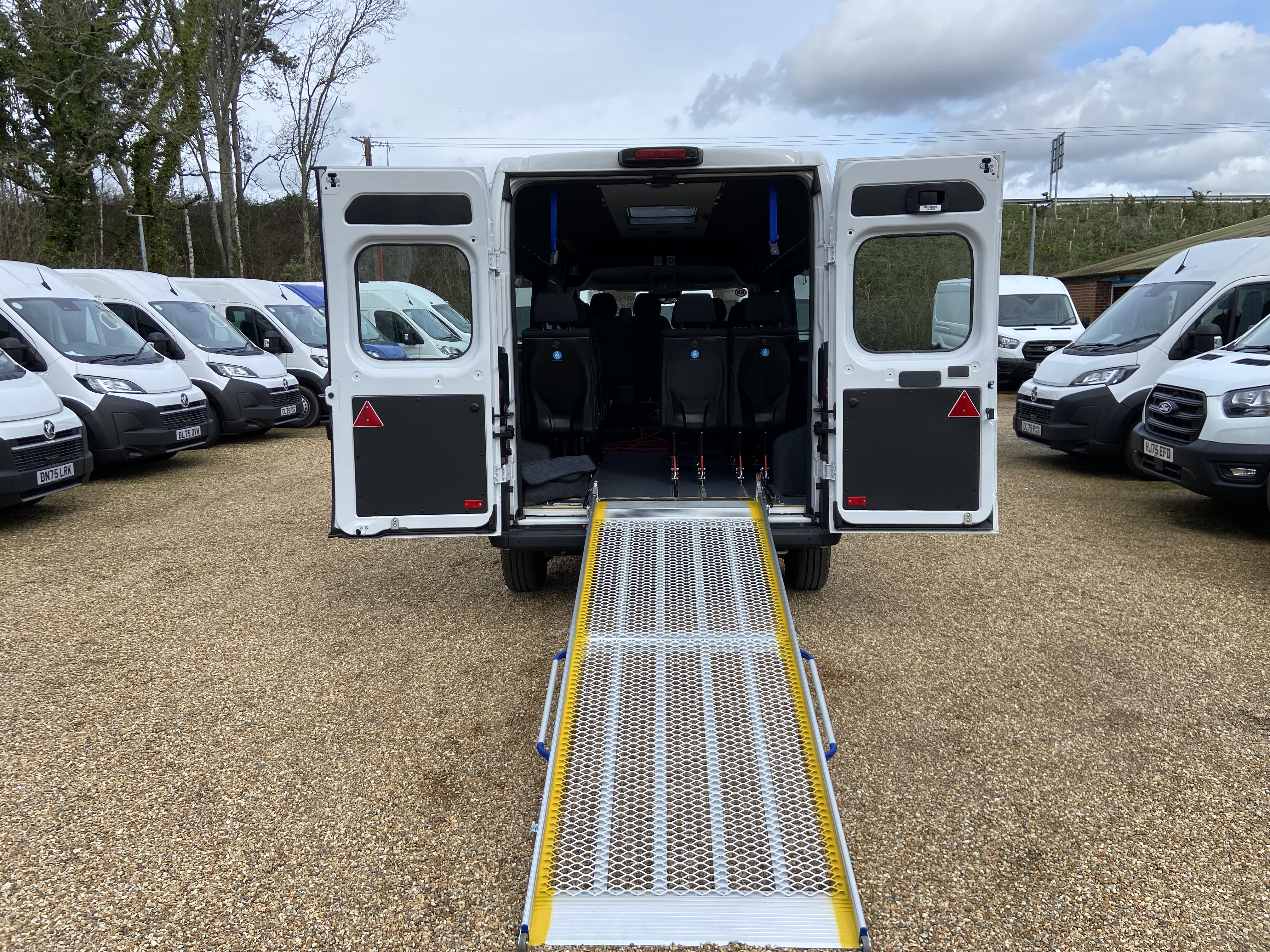 Rear access ramp deployed on the electric CVMinibus, ready for wheelchair boarding