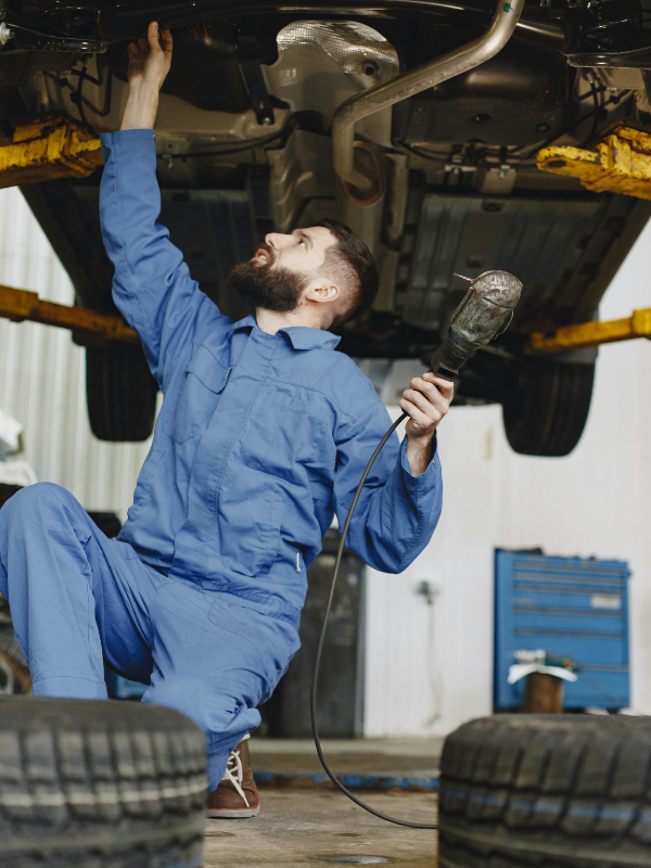 Mechanic servicing a minibus engine