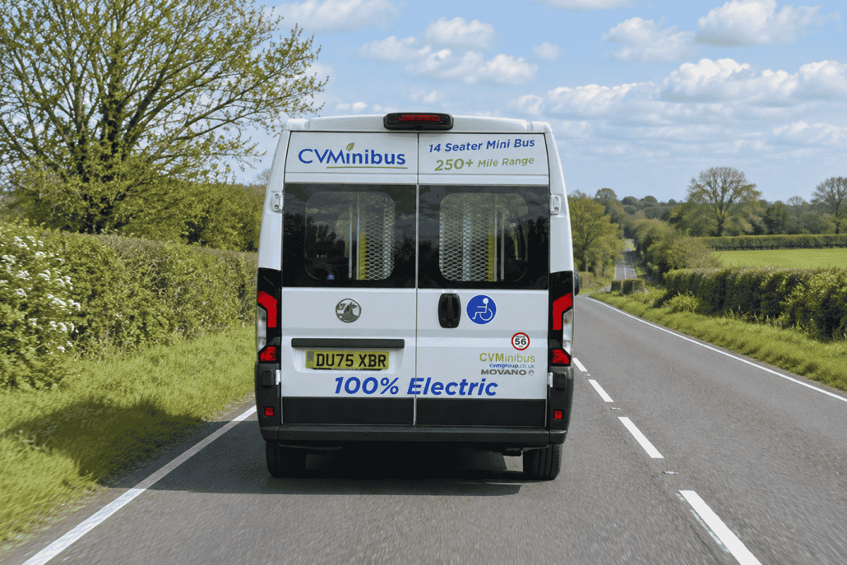 Electric minibus plugged in at a charging point