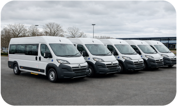 A fleet of white CVM Group vans lined up outside the CVM Group dealership